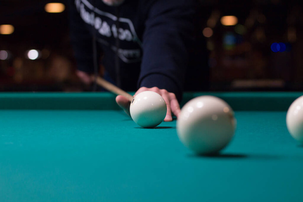 Russian billiards game in progress: player aims to shoot balls with cue - Zdjęcie, obraz