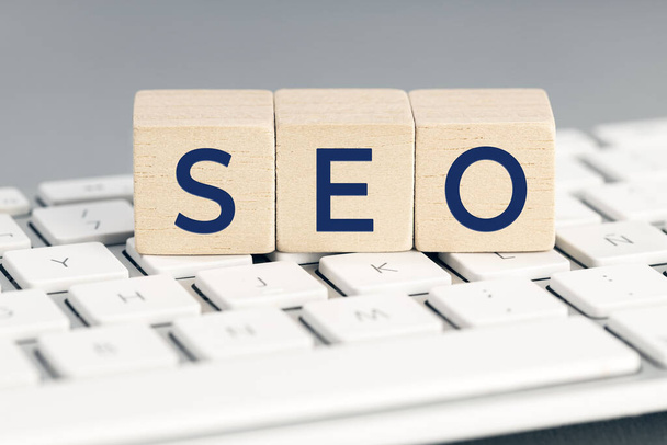 SEO word on wooden blocks on computer keyboard. Search Engine optimization concept - Foto, afbeelding