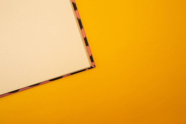 Notepad on a bright yellow background, sheets of paper, words on paper - Photo, image