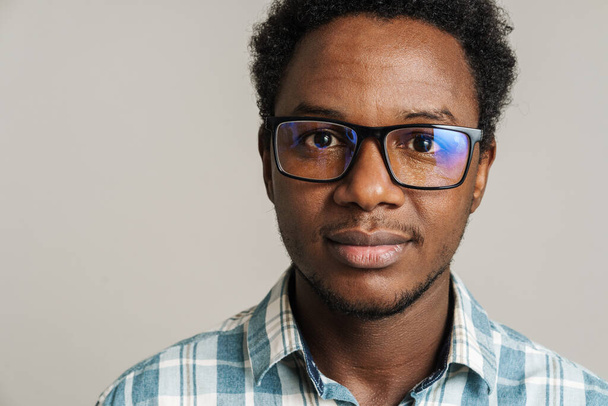 Young black man wearing eyeglasses posing and looking at camera isolated over white background - Φωτογραφία, εικόνα