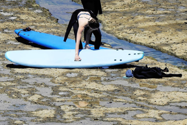 Серфингисты на берегу готовятся перед входом в воду - Фото, изображение
