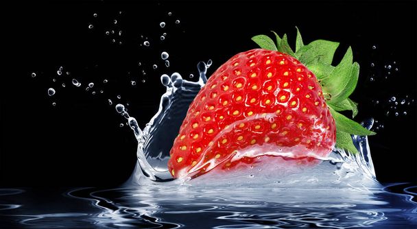 Strawberry fruit in a splash falling into the water on a black background, splashing - Foto, imagen
