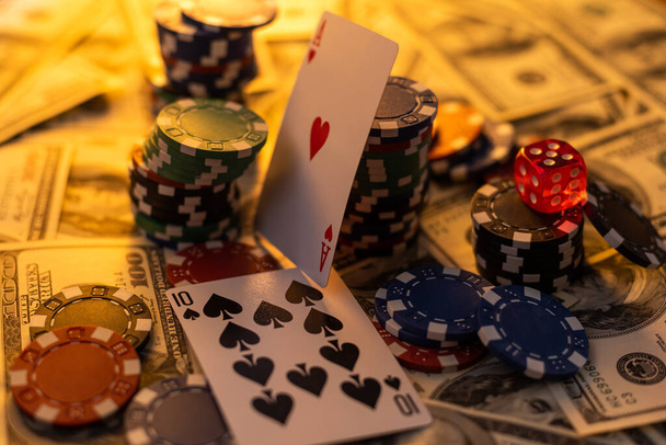 Poker cards royal flush, cash money dollar bills. Gambling, casino chips, dices. Casino tokens, gaming chips, checks, or cheques on green table in casino club. - Photo, Image
