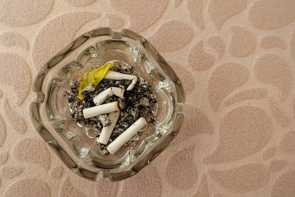 cigarette harms human health, the smoker who puts out the cigarette butt in the ashtray, - Fotó, kép