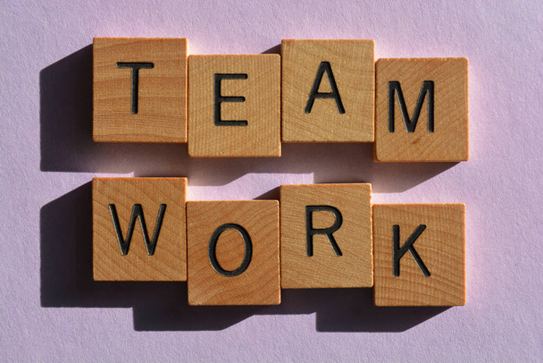 Team, Work, words in woode alphabet letters isolated on plain purple background - Photo, Image