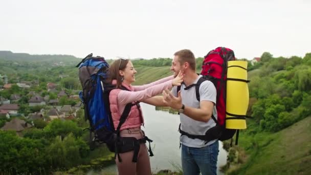 happy couple, man and woman in the mountains, travel in search of a vacation spot. they rejoices, standing against the backdrop of a beautiful landscape. vacation in the mountains - Footage, Video