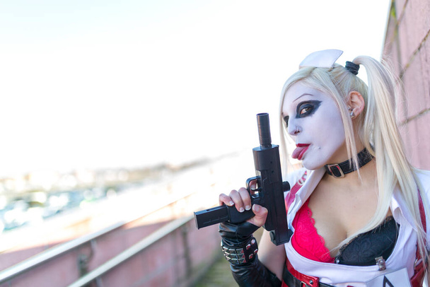 Lucca, Italy - 2018 10 31 : Lucca Comics free cosplay event around city Harley Queen with mini gun. High quality photo - Photo, Image