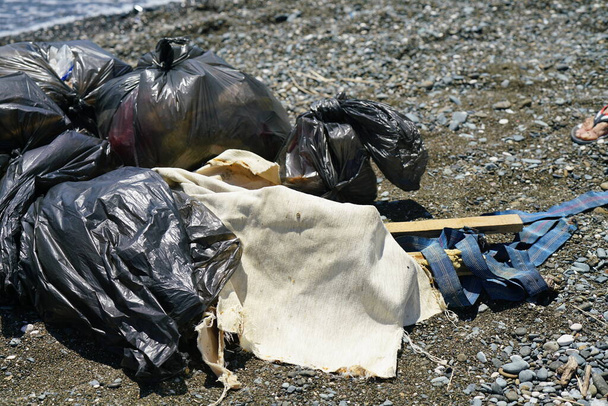 bags of collected garbage from the beach for recycling, cleaning the beach from pollution. High quality photo - Photo, Image