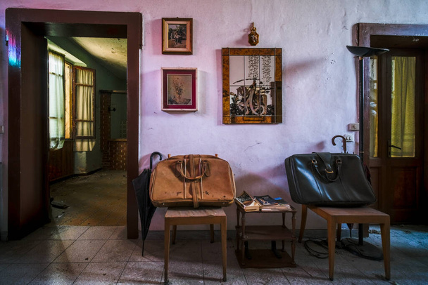 entrance with armchairs and sitting room in old abandoned mansion. High quality photo - Фото, изображение