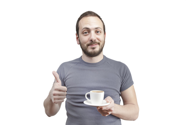 Young man drinking a cup of coffee or tea isolated white background - Foto, Bild