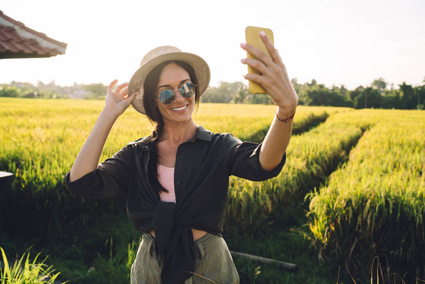  Delight female influencer shooting travel vlog from Indonesia connecting to roaming internet - Photo, image