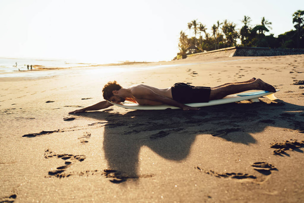 Sportive man enjoying morning time for recreating at coastline seashore at Phuket beach of Thailand - Фото, зображення