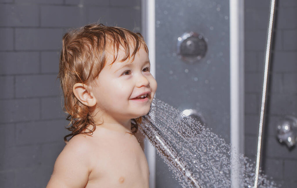 Cute child playing in bathtube. Baby showering. Portrait of kid bathing in a bath with foam - Foto, Bild