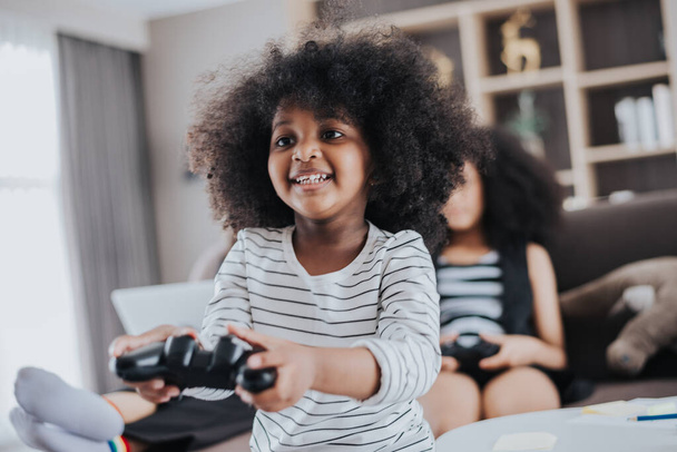 Happy african family having Fun together at Home. African kids daughter playing game with her family in living room. Happy family time. - Photo, Image