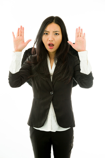 Asiática joven empresaria vestida como ángel negro haciendo stop gesture y gritando stop
 - Foto, Imagen