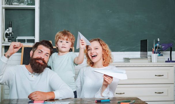 Family educational rights and privacy act. Family school partnerships examples. School kids. Pupil with paper airplane playing with parents - Foto, Imagem