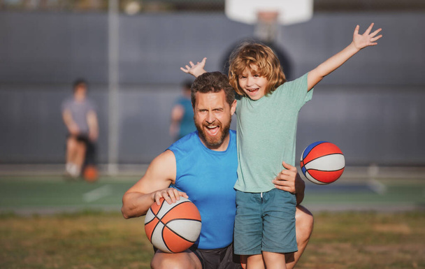 Father and son enjoying sport basketball outdoor. Childhood and parenting concept. Weekend sport man family concept - Φωτογραφία, εικόνα