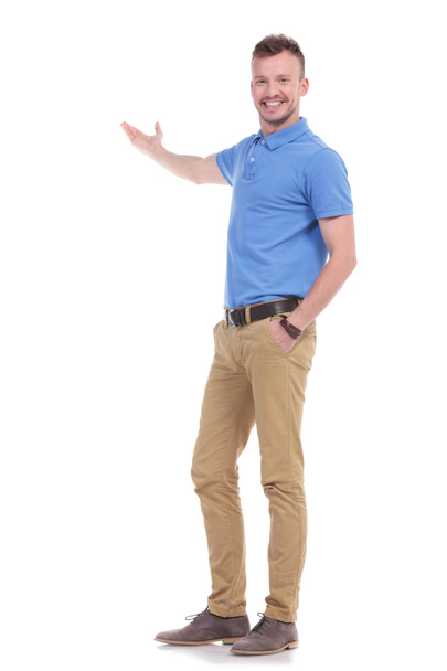 happy casual young man presents something - Photo, Image
