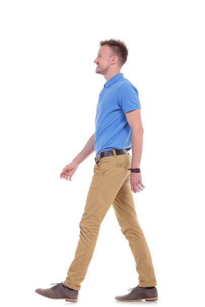 side of casual young man walking - Фото, изображение