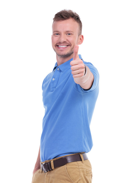 casual young man shows thumb up - Photo, image