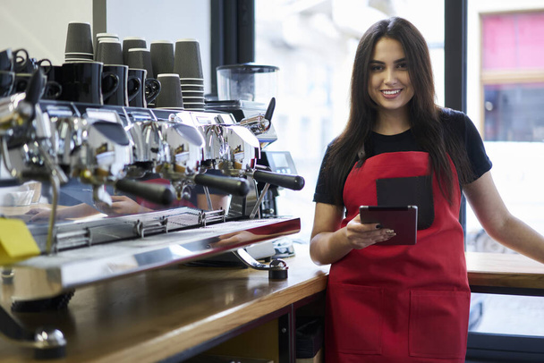 Half length portrait of cheerful caucasian woman barista using digital tablet app for checking orders online,  - Photo, Image