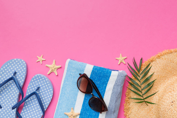 Summer vacation concept flat lay. straw hat beach accessories and towel top view. Space for text. travel concept. - Photo, image