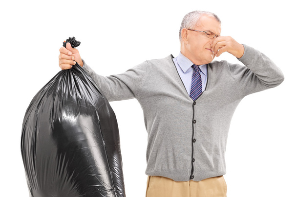 Senior holding stinky garbage bag - Foto, Imagem