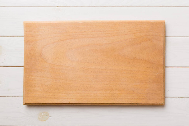 Top view of wooden cutting board on cement background. Empty space for your design. - Фото, изображение