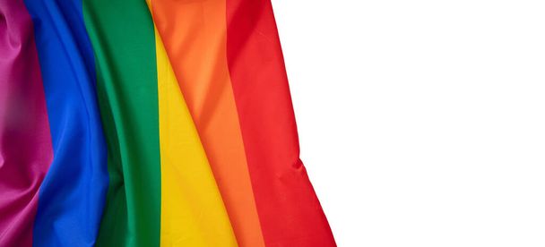 Rainbow colors textile creases, colorful cloth with ripples on white background, copy space. LGBT Gay pride template, top view, banner. - Photo, image