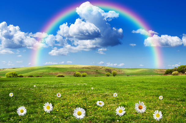 Sunny day with rainbow and fluffy white clouds - Photo, Image