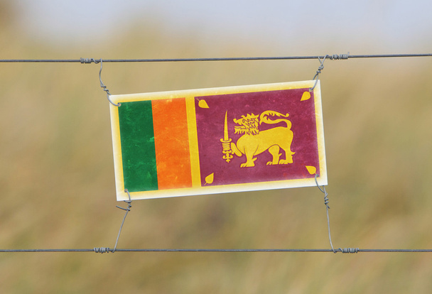 Border fence - Old plastic sign with a flag - Photo, Image