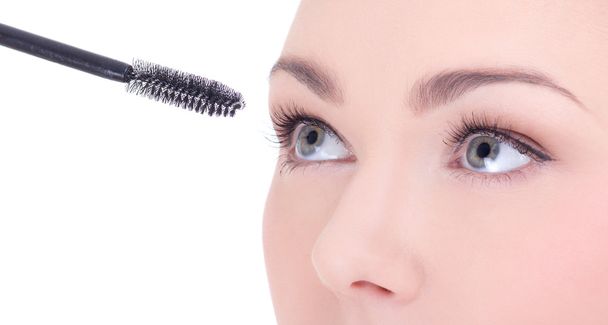 close up portrait of beautiful woman applying mascara on her eye - Photo, Image