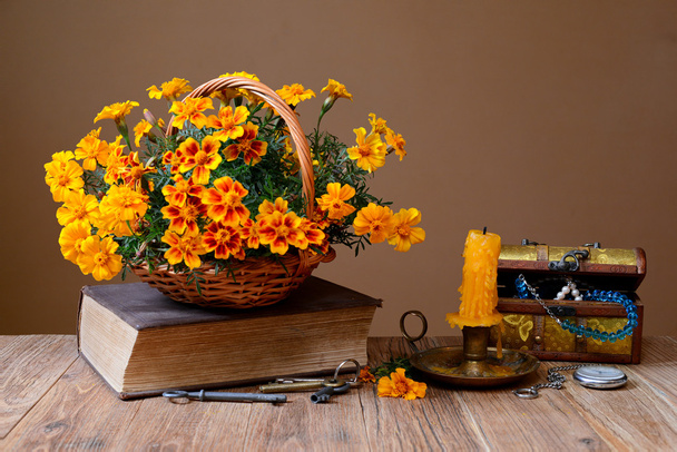 Flowers in wicker baskets, books and jewelry - Photo, Image