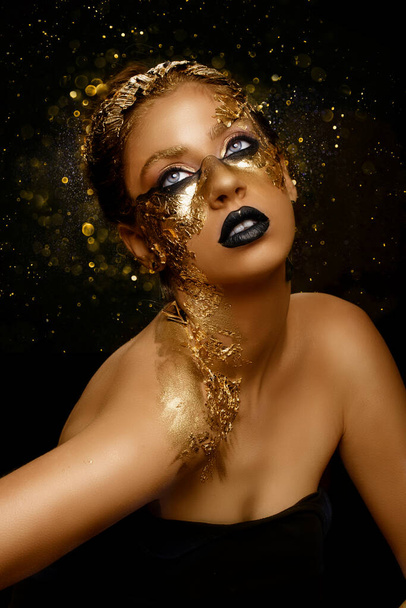 Fashion art Golden skin. Girl Model with Festive Golden Glamor Brilliant Professional Makeup. Creative makeup with golden foil. - Fotoğraf, Görsel