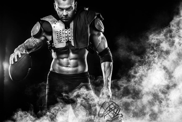 American Football player on black background with copy space - Foto, afbeelding