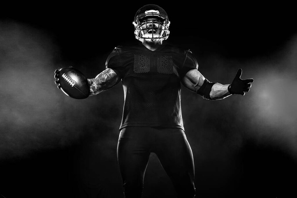 American Football player on black background with copy space - Zdjęcie, obraz