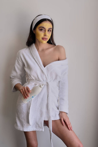 Face peeling mask, spa beauty treatment, skincare. portrait of a girl on a white background with a facial mask - Φωτογραφία, εικόνα