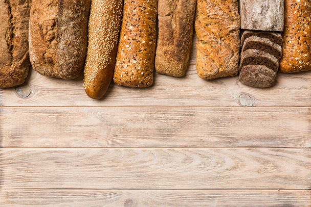 Homemade natural breads. Different kinds of fresh bread as background, top view with copy space. - Foto, imagen