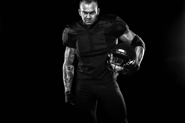 American Football player on black background with copy space - Zdjęcie, obraz