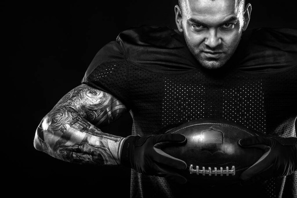 American Football player on black background with copy space - Foto, immagini