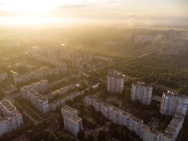 Sun shining on morning cityscape in residential district. Aerial colorful view above buildings and streets in sun light, Pavlovo Pole, Kharkiv city, Ukraine - Foto, Imagen