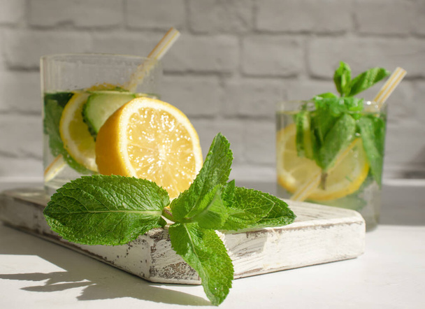 Water with lemon, cucumber, mint on a light background - Foto, Imagem