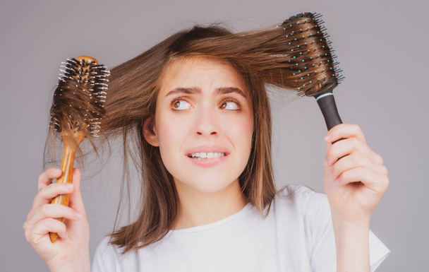 Sad girl looking at damaged hair, the hair loss problem. Isolated, copy space - Foto, Imagen