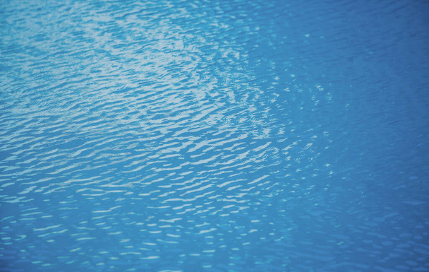 Water background, ripple waves. Blue swiming pool pattern. Sea surface. Water in swimming pool with sun reflection. Banner with copy space - Фото, изображение
