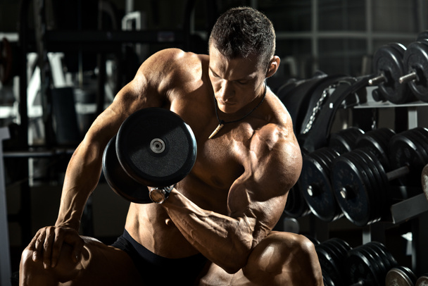 Bodybuilder in gym - Photo, image