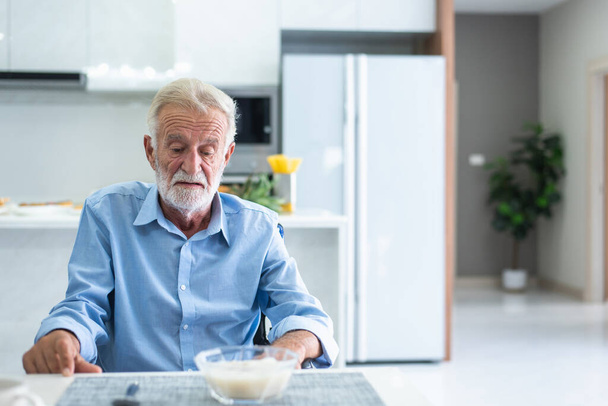 An elderly man has anorexia. Can't eat rice in the morning of the day - Fotografie, Obrázek