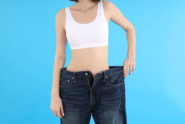 Concept of weight loss with slim young woman - Foto, Bild