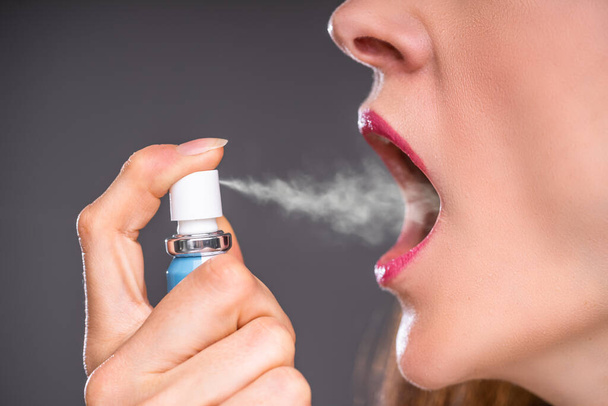 Close-up Of A Woman Applying Fresh Breath Spray - Фото, зображення