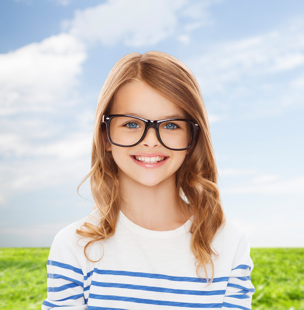 smiling cute little girl with black eyeglasses - Foto, Imagem