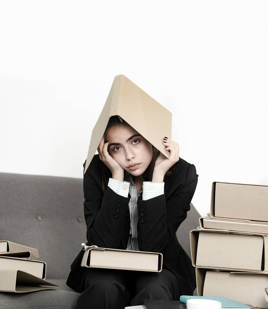 Sadness depressed businesswoman with folder on head, frustration secretary girl, stressed employee working overtime with too much work, office problem - Foto, imagen